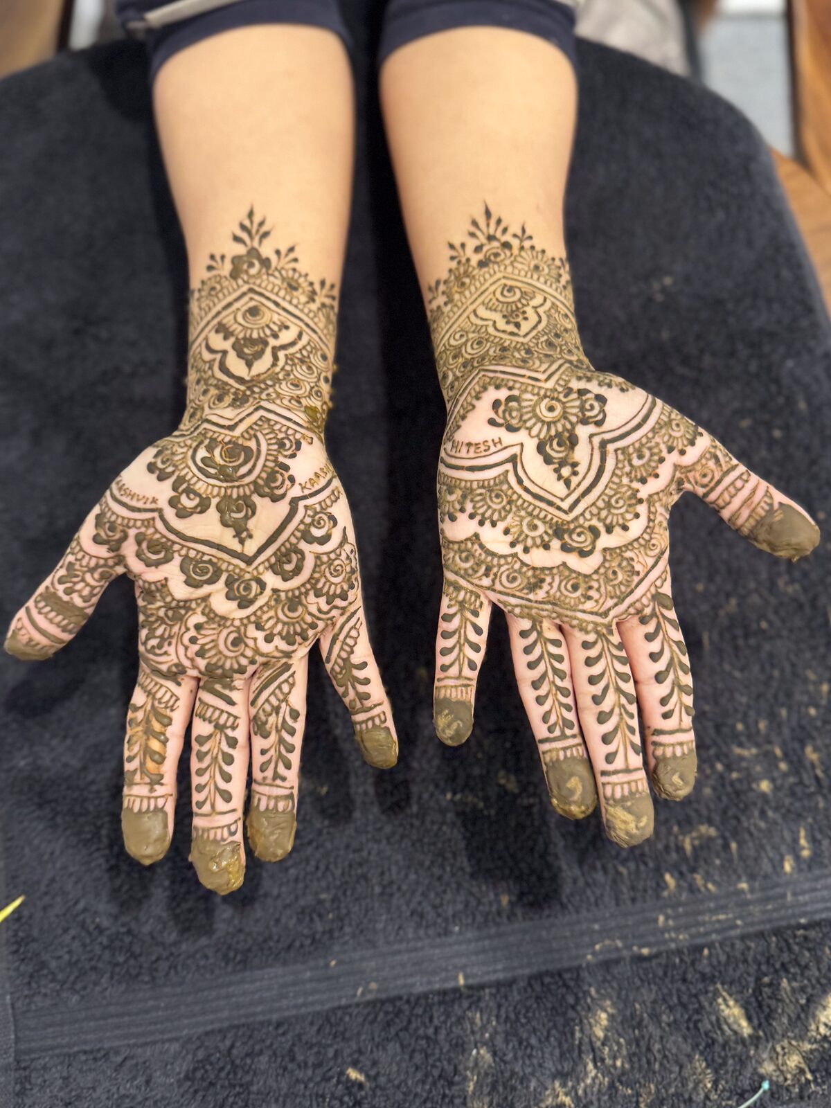 Bridal hands, both sides, on black cloth