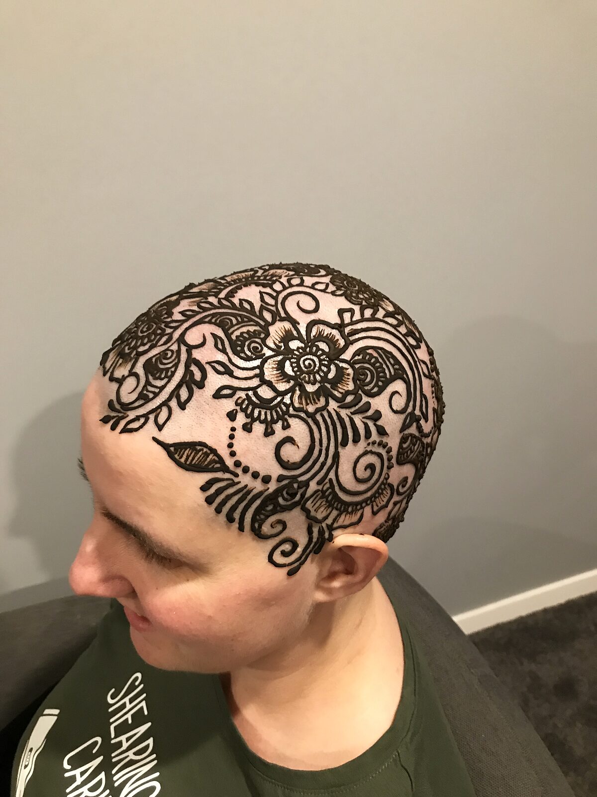 A henna crown drawn over a shaved head