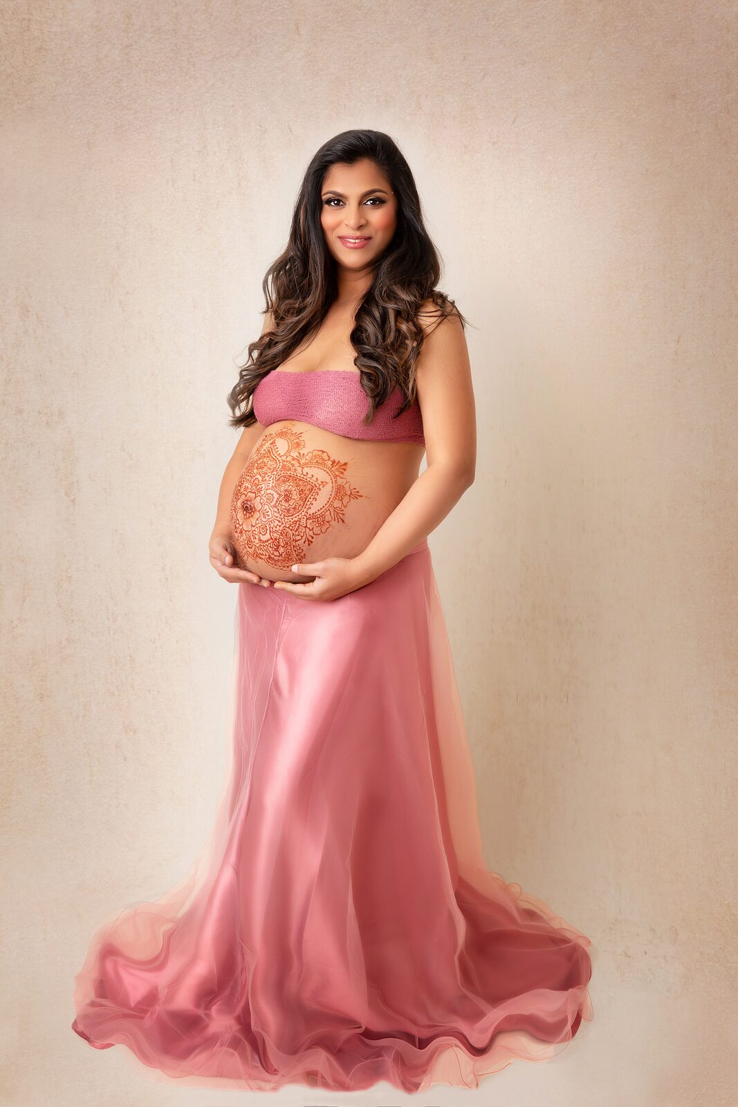 Maternity portrait with a henna design across the belly